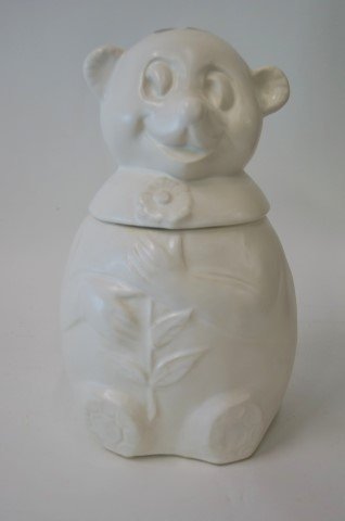 McCoy Pottery Cookie Jar: Matte glazed pottery cookie jar. Seated bear with flower. Signed. 11"H.