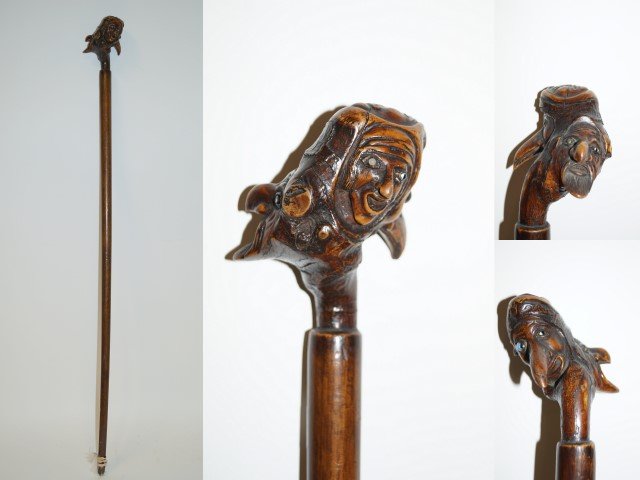 19th C. Northwest Inuit Wood Carved Staff: Carved wood whimsical staff. Four(4) headed well detailed mask decoration. Inlaid glass and stone eyes. Remnant of feather decoration; 37in. H.