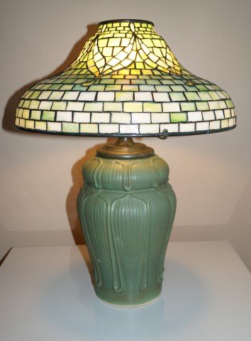 Tiffany Studios Tyler Leaded Lamp Signed: Leaded Tyler 16in. glass lamp on a Grueby style pottery base. Signed on shade; (Lamp is being sold for unpaid account in Oct.25th auction) 22in. H. x 16in. D. shade