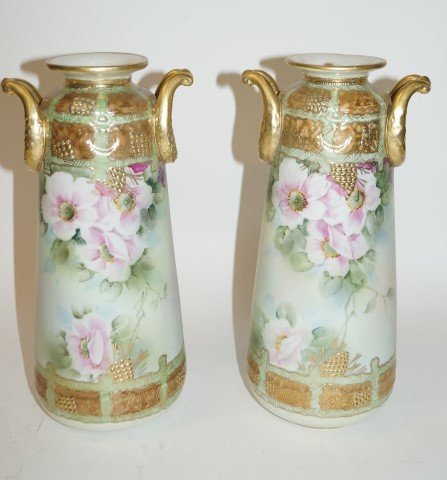 Pair of Nippon Porcelain Vases: Pair of ornate gilt and painted porcelain vases. Double ring handled. Floral decoration. Marked at underside; 12in. H.