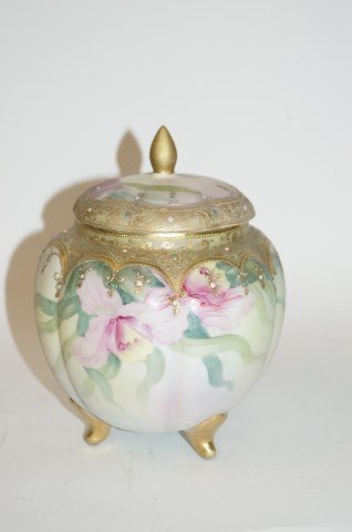 Nippon Porcelain Cracker Jar: Gilt and enameled blown out porcelain cracker jar. Market at underside; 8in. H.