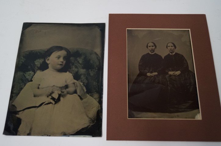 Oversized Tintypes inc. Post-Mortem: Two oversized Tin Types, one what seems to perhaps be a post mortem image of a young girl on a floral couch holding an unidentifieable object; the second is a pair of sisters who might be twins . Over