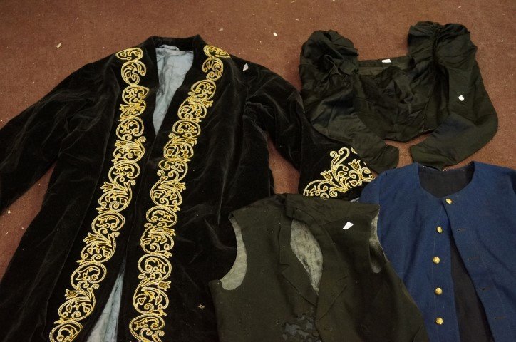 Dealer's Lot Vintage Clothing: The lot includes a man's vest; Victorian ladies mourning jacket; military cape and embroidered smoking jacket ranging in size.