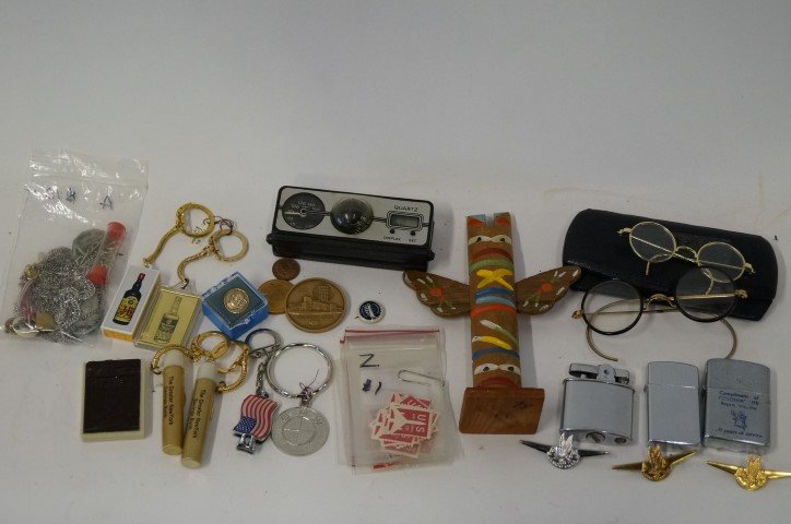 Dealer's Lot: Large bag lot to include early eye glasses,lighters, medalliions, 11 cent stamps, American Airline Wings, a wind gauge, wooden totem etc.