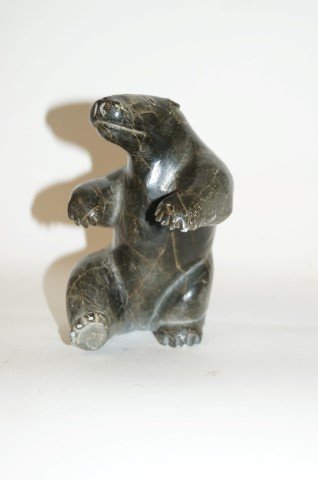 Inuit Carving of a Polar Bear: Seated bear figure, marked on the underside E9876 6"H. x 4"W