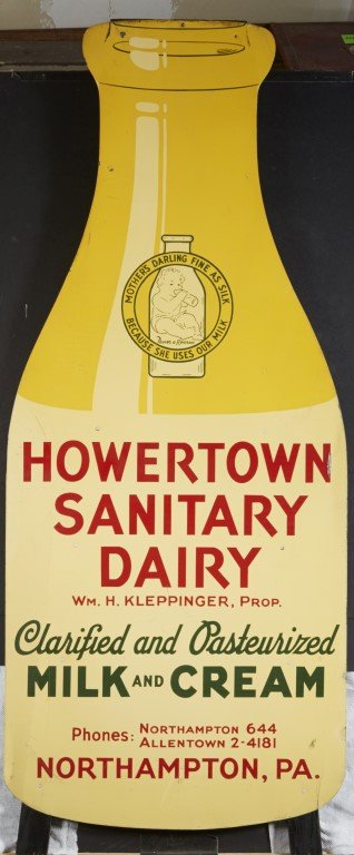 Howertown Dairy Tin Sign: In the form of a milk bottle. Lithography on tin mounted on a wood frame for standing display. Howertown Dairy Northampton, PA. ; 47" x 19"