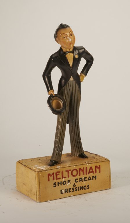 Meltonian Figural Display: Shoe Cream & Dressings" Featuring man in tuxedo holding a top hat. Painted plaster. Some chipped paint; 17" x 8