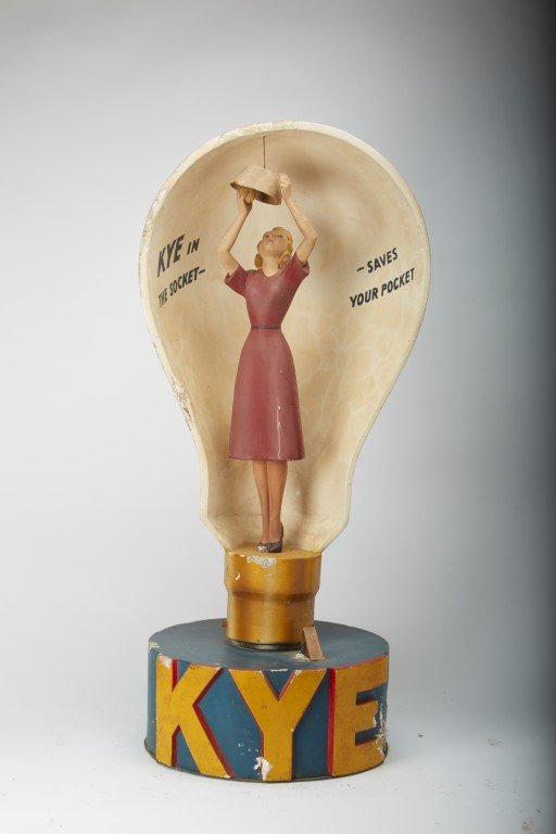 Kye Light Bulb Counter Display: Kye in the socket- saves your pocket."Composition plaster Condition: As is.; 31" x 13