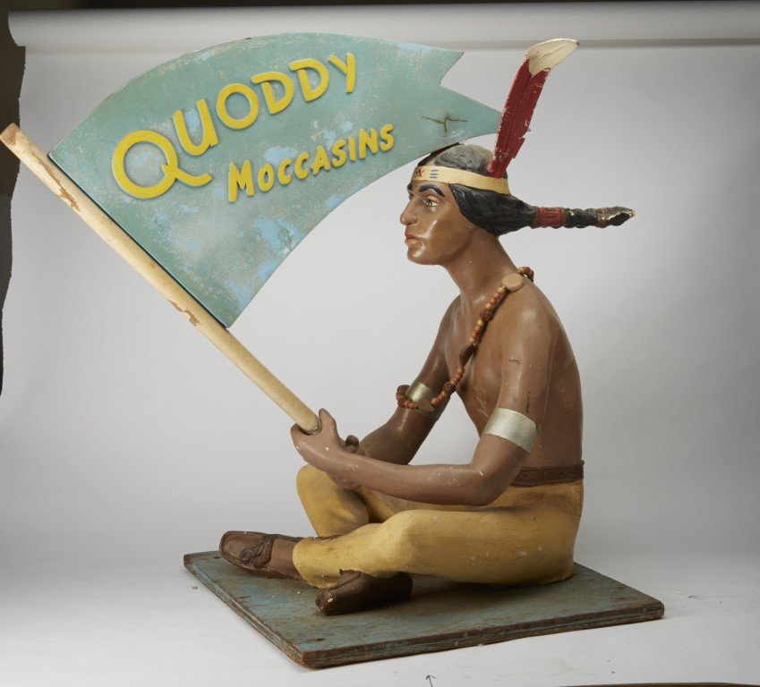 Quoddy Moccasins Display Sign: Compostion. Wooden base. Provenance: James D. Julia. Lot #348; 31" x 20"