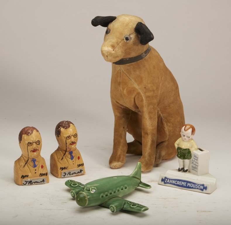 Advertising Lot (5): Mohair Victor Dog with the product advertisement on collar, Zahncreme Mouson Toothpick holder, (2) Theodore Roosevelt Chalkware Bust, and a German Airplane Decantor for Hulstkamp Liqour. ; Dog: 11"