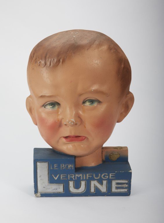 Le Bon Vermifuge Lune Stand: Baby's Face with tears. Painted plaster. Condition: Some Paint chipping. ; 14"