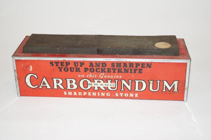 Carborundum Brand Knife Sharpener: "Step-up and Sharpen your Pocket Knife." Lithography on tin. 11 1/4" l x 3 1/4"h.