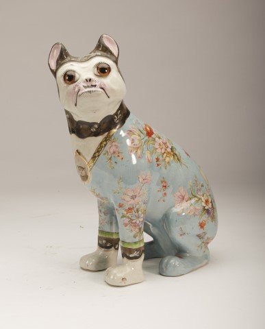 Galle Pug Dog: Faience Figure of a dog, floral decorated wearing a "necklace" with a miniature portrait of a cat. It has glass eyes. Turn of the century. . Provenance: Christies March 29, 1996 Lot: 279; 13"