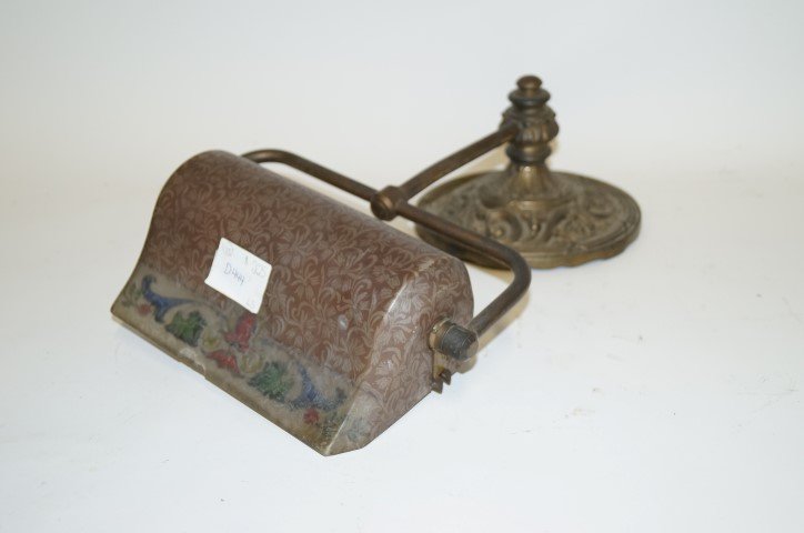 Handel Roll Top Desk Lamp: Reverse painted floral bordered shade with chipped ice effect. Remanants of label at the inside. Outside chip at lower shade will be visible in the photo. Ornate dore bronze base. ; 7 1/2"D. (base) 9"