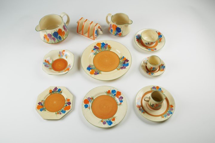 Clarice Cliff Bizarre Line: Crocus (89 pcs.): 5 1/2" Plate -4. 5 3/4" Plate -16. 6" Plate- 5. 9" Plate- 7. 4" Plate- 7. 4" Plate- 13. Demitasse Saucer with 3 cups. 7 3/4" Plate- 7. 6 3/4" Plate- 16. 2" H Espresso cups- 5. 1 Saucer 4" H. 1 Saucer