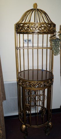 Unusual Gilt Wine Rack: With sections at the bottom for wine bottles. Glass shelf at the aviary like top creates a space for liquor bottles or glassware. Door at bottom. Top will take a half round shelf and the middle will t