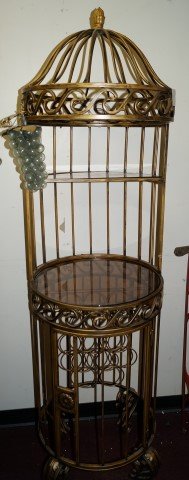 Unusual Gilt Wine Rack: With sections at the bottom for wine bottles. Glass shelf at the aviary like top creates a space for liquor bottles or glassware. Door at bottom. Top will take a half round shelf and the middle will t