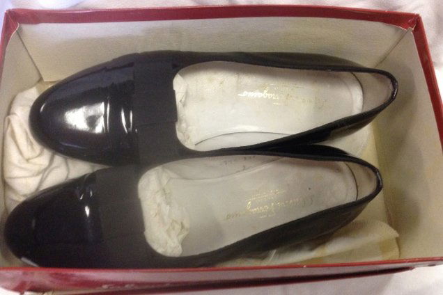 Salvatore Ferragamo Patent Leather Opera Shoes: Size 10-1/2D. Salvatore Ferragamo patent leather Opera shoes with flat grosgrain bows. Marked at the interior Salvatore Ferragamo Studio, Made in Italy; also marked at the base. In worn condition. 11-