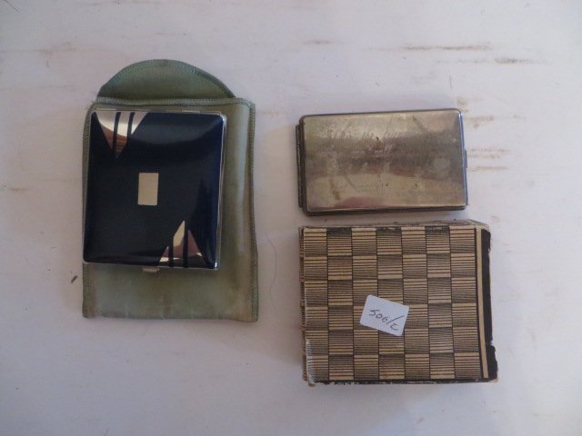 Two Collectible Compacts: Marlene Dietrich Compact, "It is the Friends You Can Call at 4AM that matter"; and an Art Deco black and silver compact. 4"L and 3"W and 5"L and 4"W.