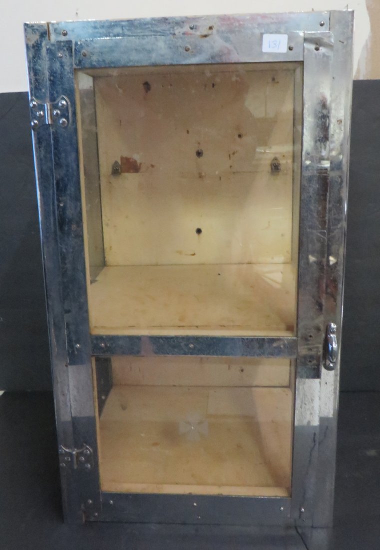 Medical Office Cabinet. Chrome and Glass: Wooden back. Wooden shelves. Missing one glass panel on the side bottom. 21 1.2"H. x 12"W.