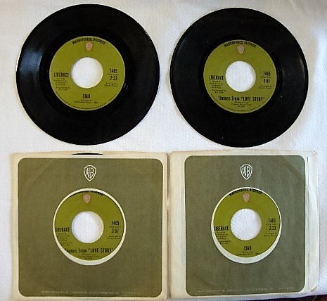 FOUR LIBERACE 45 RPM RECORDS: Warner Bros. Ciao and Themes From "Love Story"; All 7465 Arranged by Emory Gordy. In original sleeves. In his autobiography, Liberace, on page 299, recounts a writers review of his performance in Melb