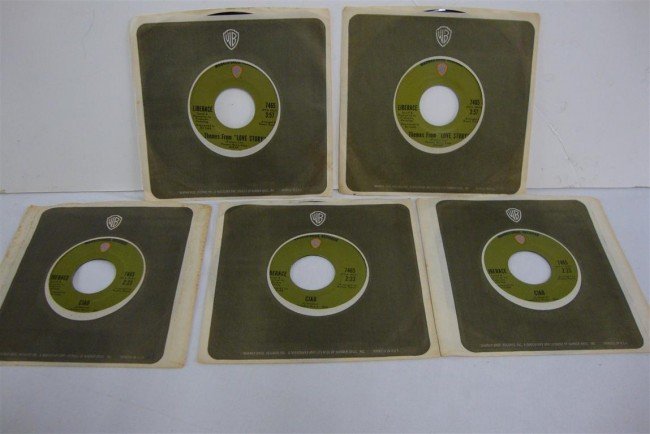 WARNER BROS 45's LIBERACE'S OWN RECORDS (5): Themes from Love Story and Ciao 7465. In protective sleeves (five in the lot.) With a certificate of authenticity