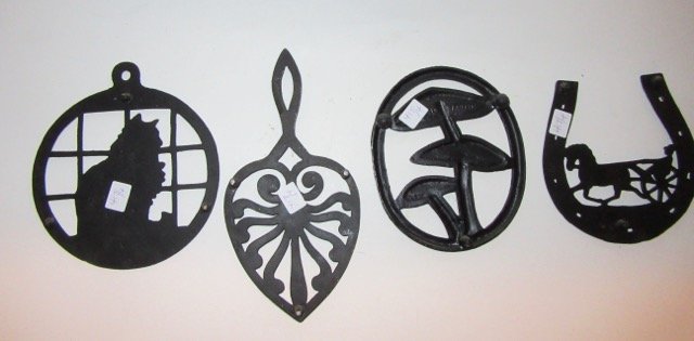 Cast Iron Trivets inc. Griswold (4): One marked Griswold Trivet No. 1727;one marked J. Z. H. 1952;horseshoe shaped. Four in the lot.