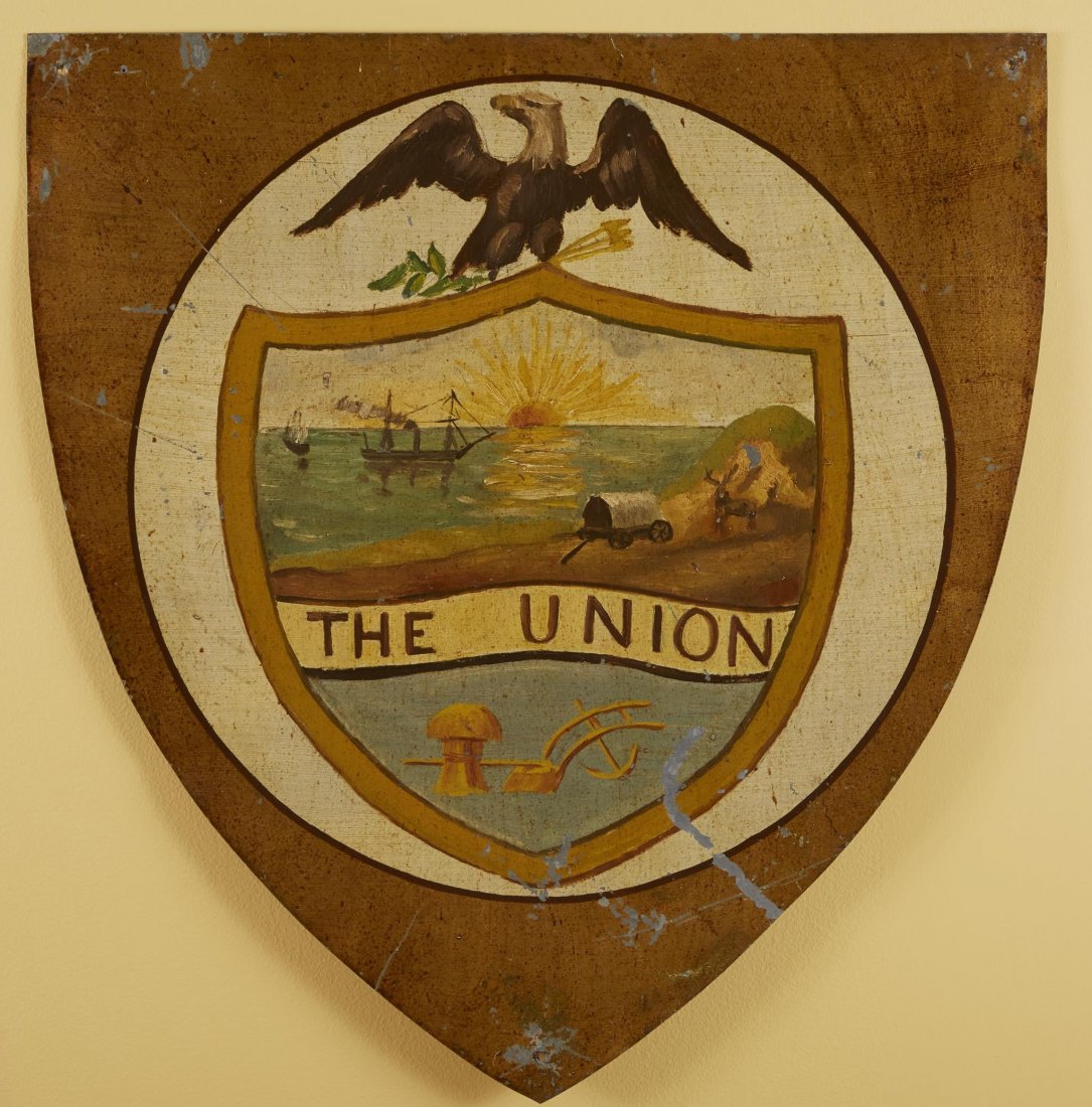 Washington Centennial Plaque: Plaque of the Union, painted shield with eagle Further depicts two ships at sea and a covered wagon and moose. Used in the Washington Centennial on Wall Street as a decoration for the sub treasury bui