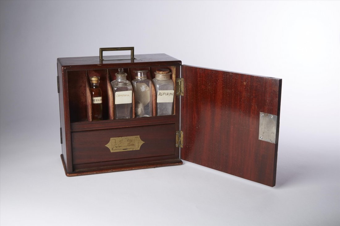 English Apothecary Cabinet: Marked Dinneford Family Chemists. Brass Handles. Door on both sides open to reveal antique apothecary bottles. Drawer on each side. 8 3/4"H. x 9 1/4" W x 4 3/4"D.