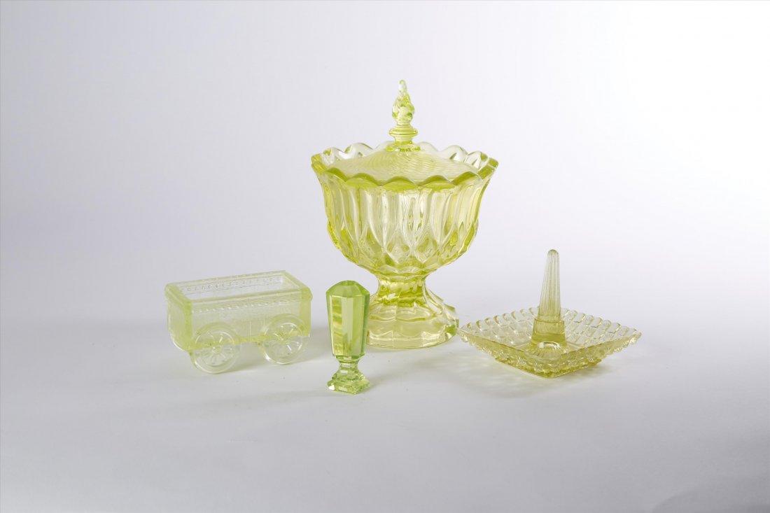 Vaseline Glass Lot (4): The lot is comprised of a rare seal; a ring holder; a covered comport and a wagon. 2"H. to 7"H.