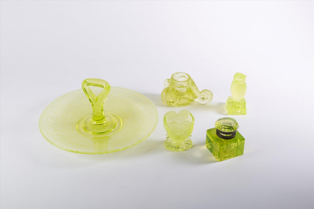 Collector's Lot Vaseline Glass (5): A handled serving dish; an owl; a heart shaped eye rinser; an inkwell (top unhinged) and a figural elephant head ink pot Varying sizes 10"W to 2 1/2"H.