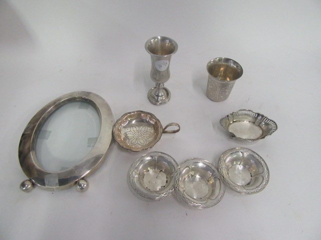 Sterling Silver Items. (8): Nut dish. Tea strainer. Frames(2). Nut dishes (3). Kiddish cup.Small goblet. Varying sizes.