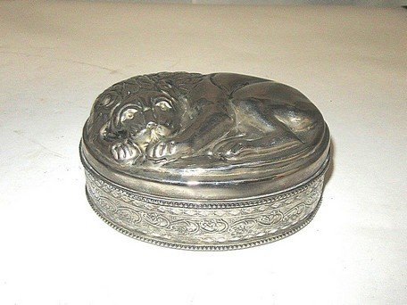 Ornate Lion Silverplate Box: Highly repoussed edge decorations with bandings to box and bottom of lid. Bas relief lion on the top 3"H. x 7"L.