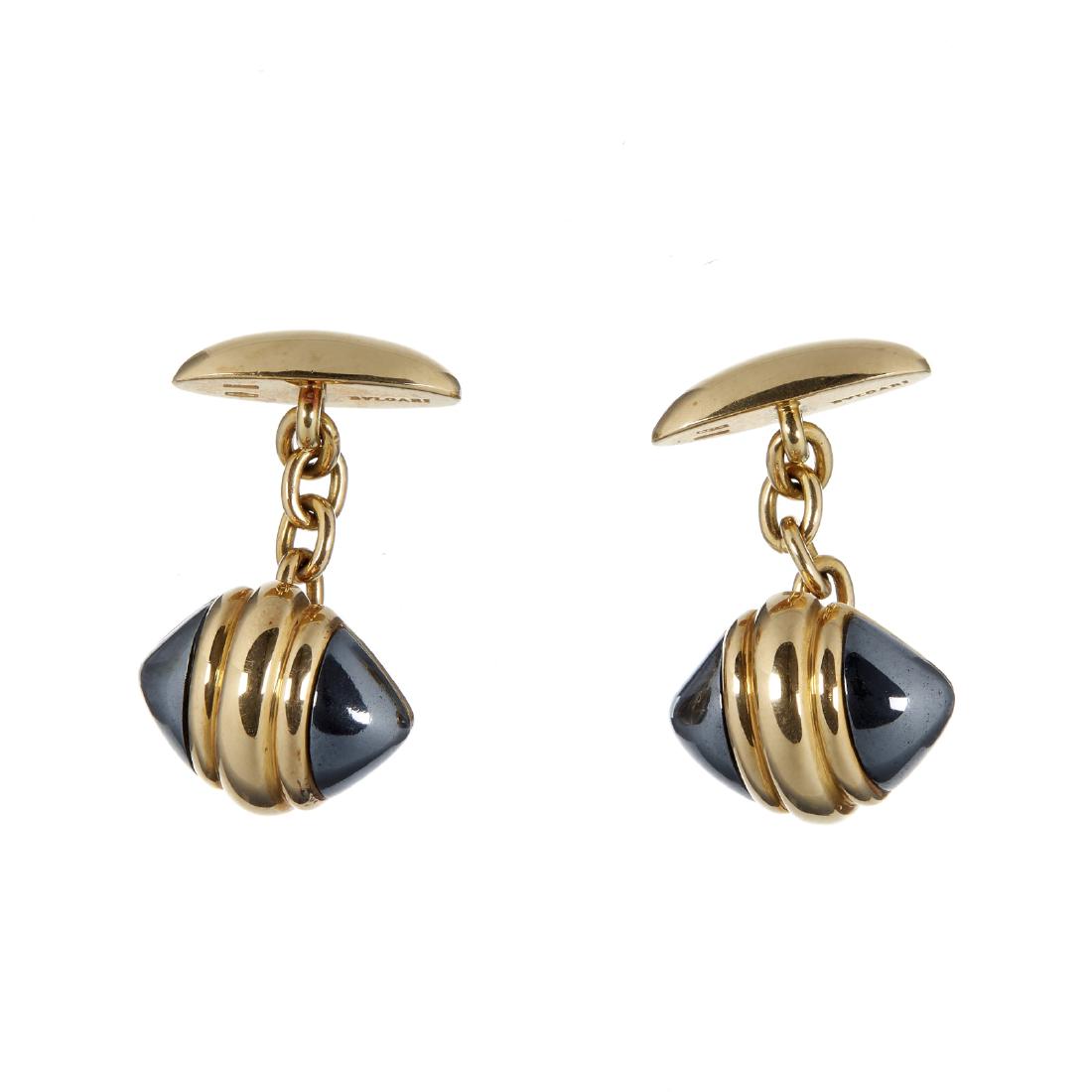 A pair of hematite and gold coloured cufflinks by (1 of 2)