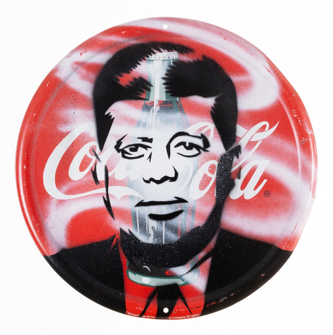 Pure Evil (b.1968) Coca-Cola Bottle JFK: Pure Evil (b.1968) Coca-Cola Bottle JFK Spraypaint on vintage signage, 2017, signed, dated and inscribed ‘Venice Beach’ in black ink verso, overall 310mm diameter (12 1/4in)