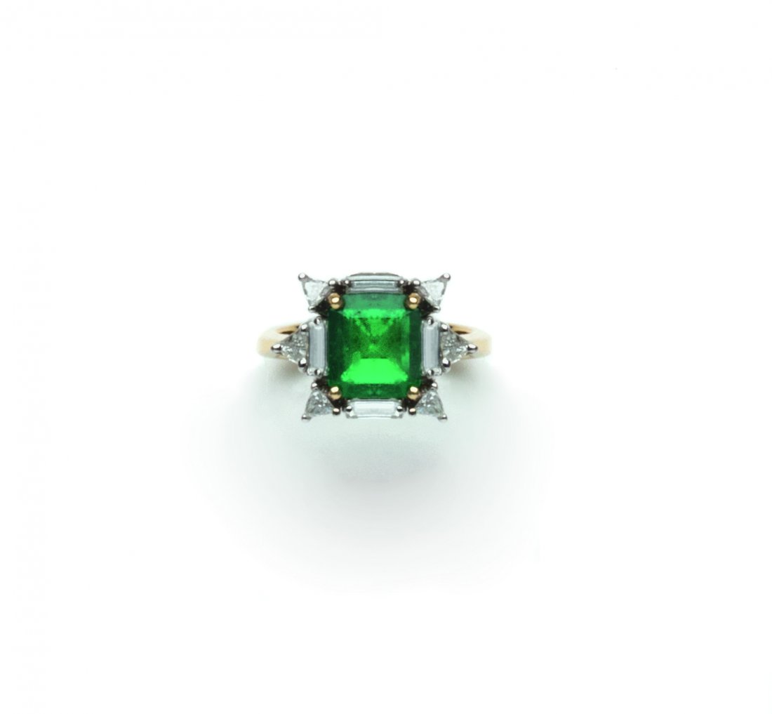 An emerald and diamond ring set with a step-cut emerald: An emerald and diamond ring set with a step-cut emerald weighing approximately 2.20 carats, framed with baguette and triangular-cut diamonds weighing approximately 1.60 carats in total, size 11/51. Ac