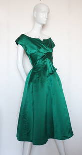 Christian Dior New York Green Silk Satin Dress, c.1956: Christian Dior New York Emerald Green Silk Satin Cocktail Dress, c.1956. Labelled 'Christian Dior New York Inc.' and 'The French Shop /Stamford / Connecticut'. Neckline of the dress resembles of the