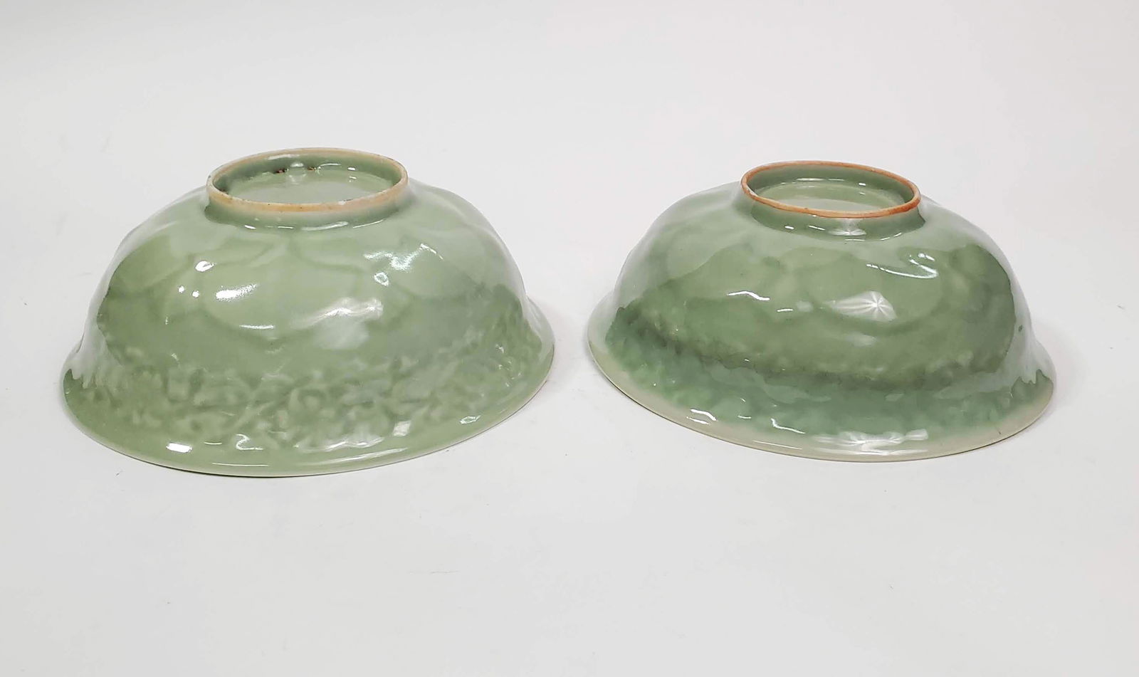 Pair of Chinese Celadon Glazed Moulded Bowls: Pair of Antique Chinese Celadon Glazed Moulded Bowls, ca. 20th century.