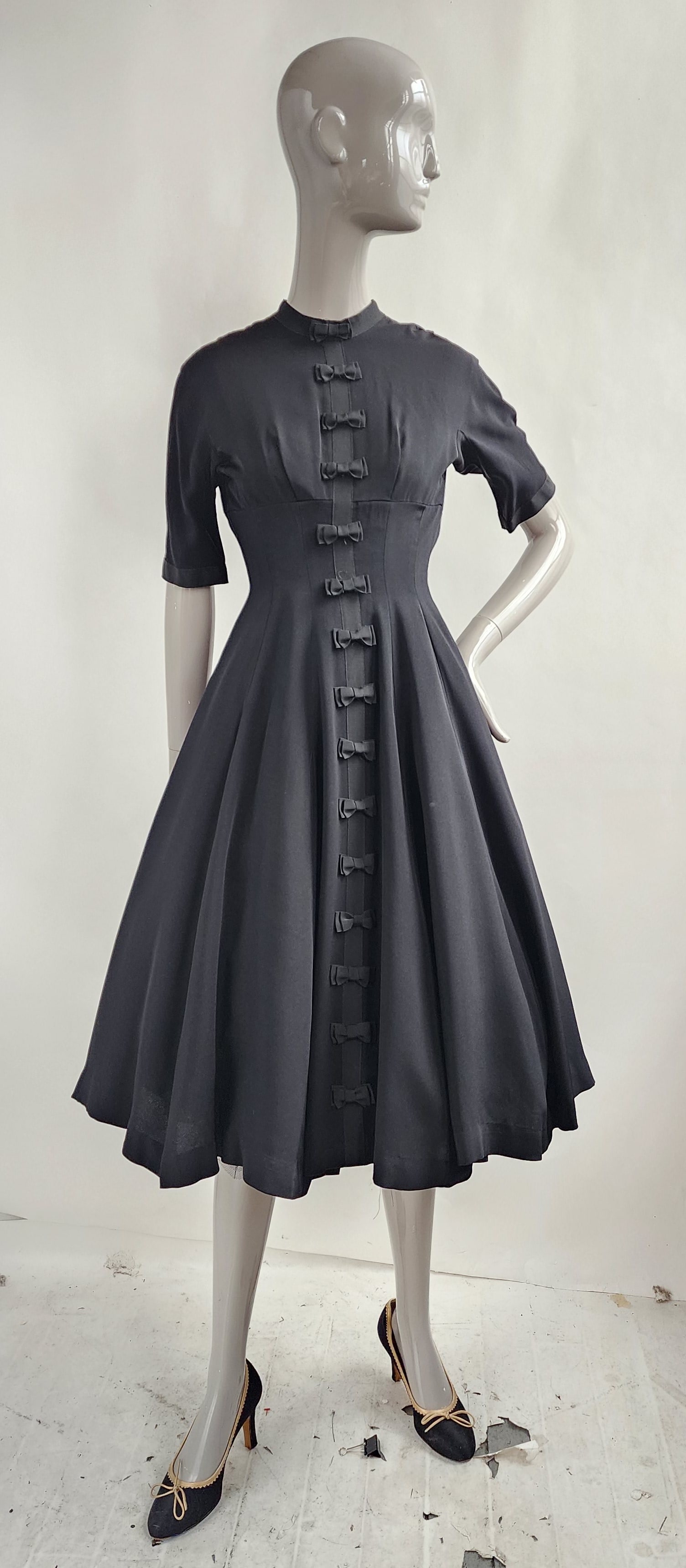 Jeanne D'Arc Black Rayon Dress with Bow Details, 1950s: Jeanne D'Arc Black Rayon Dress with Bow Details on Center Front, 1950s.