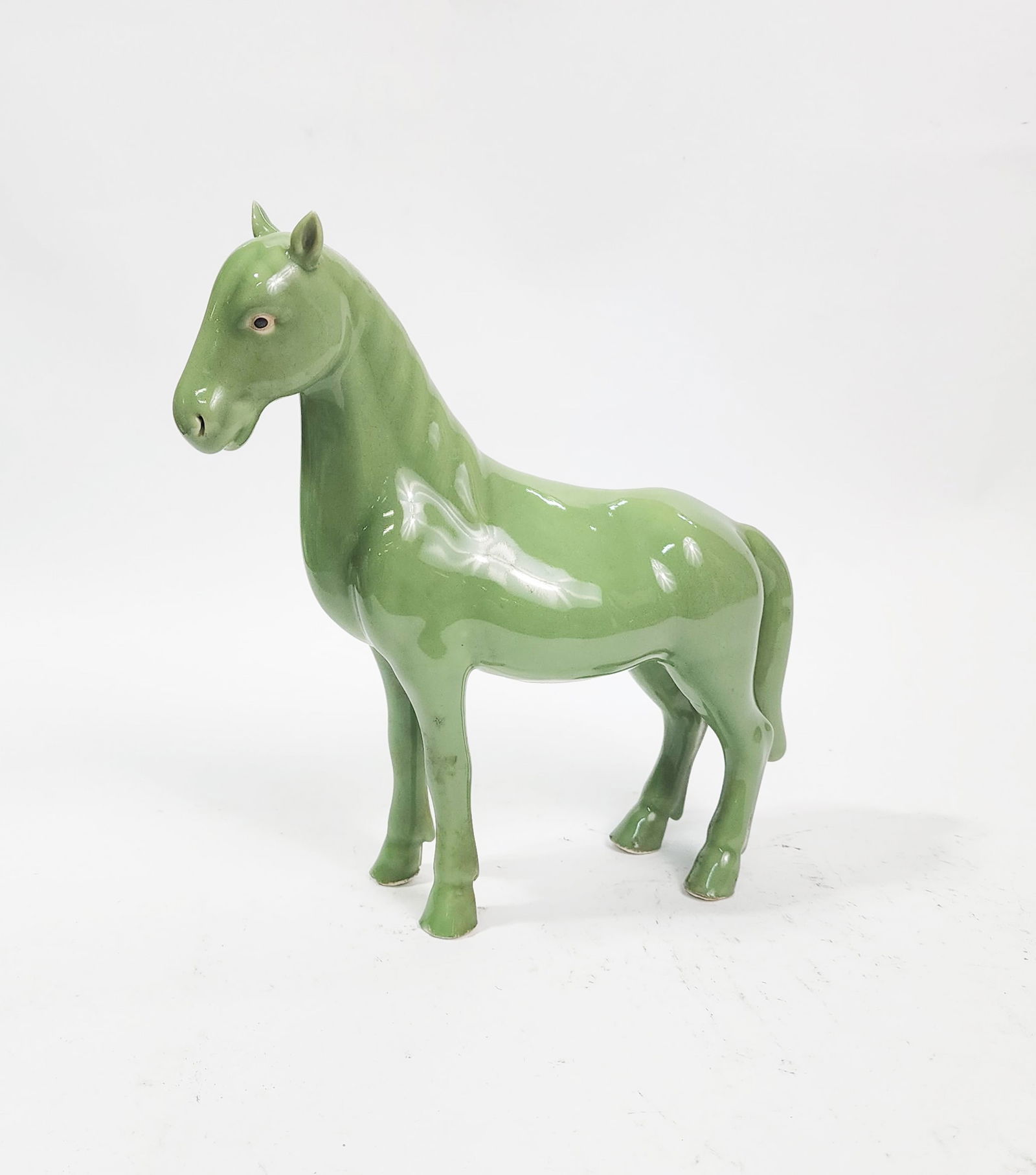 Chinese Celadon Glazed Porcelain Horse: Chinese Celadon Glazed Porcelain Horse, h. 9.5 inches, ca. 20th century.
