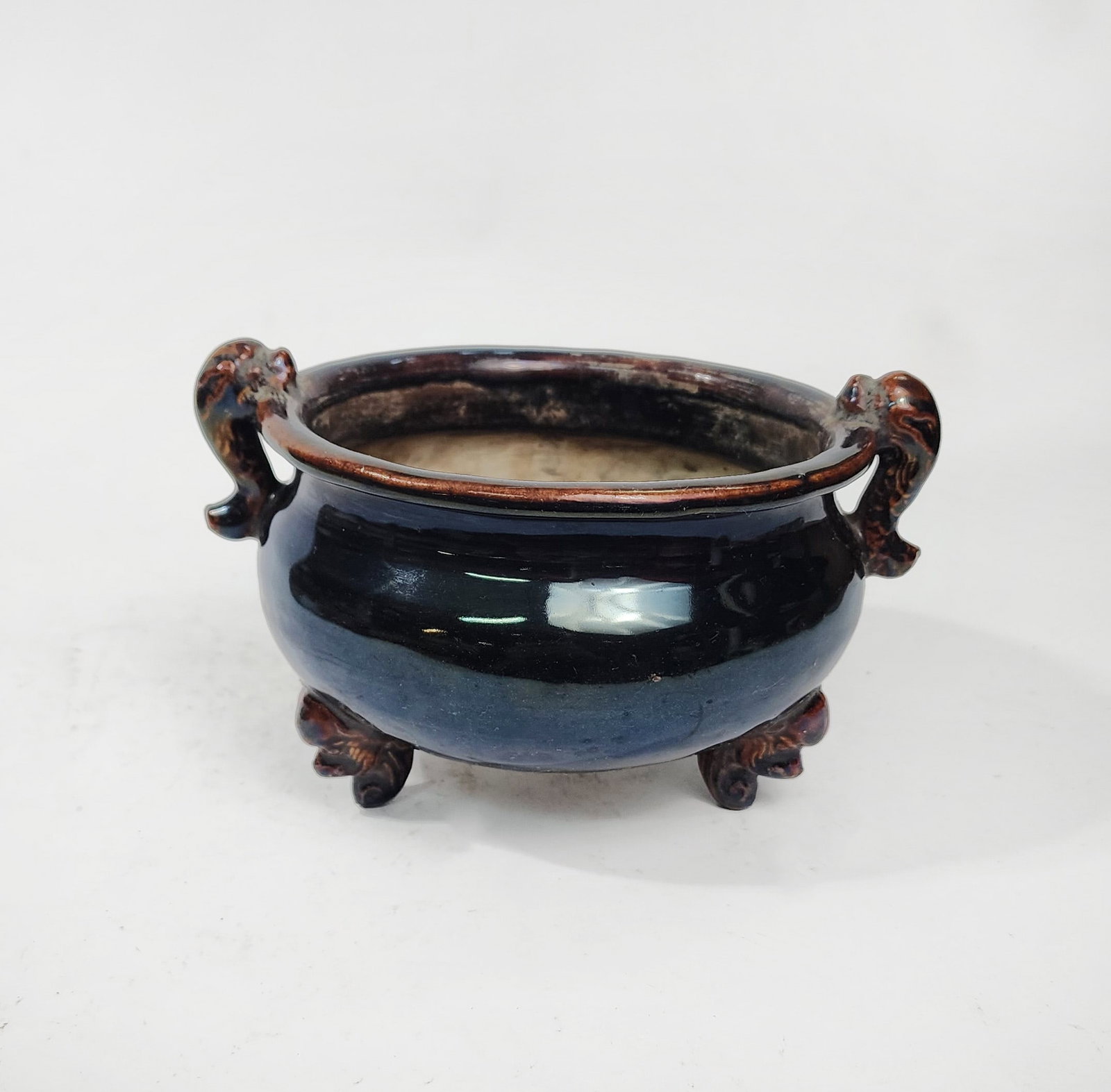 Antique Chinese Brown Glazed Tripod Footed Censer: Antique Chinese Brown Glazed Porcelain Tripod Footed Censer, d. 7.5 inches, h. 4.5 inches, ca. 20th century.