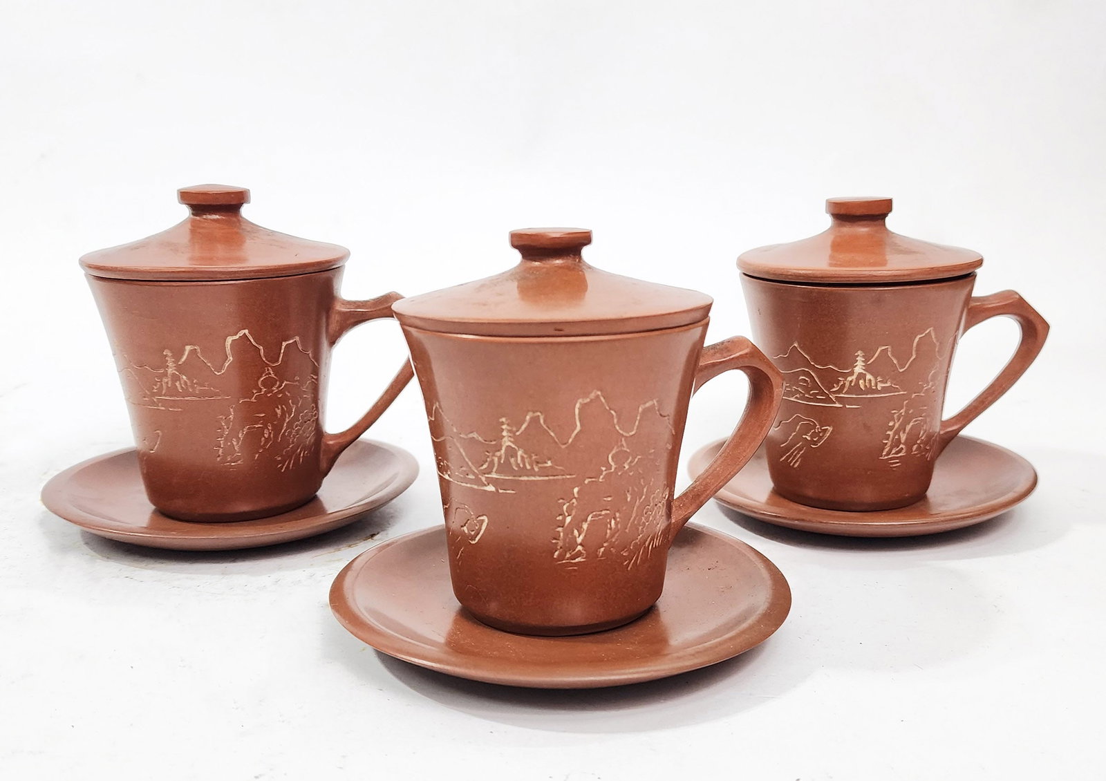 Set of 3 Chinese Qinzhou Clay Lidded Cups & Saucers: Set of 3 Chinese Qinzhou Nixing Clay Lidded Cups & Saucers, h. 4 inches, ca. mid 20th century.