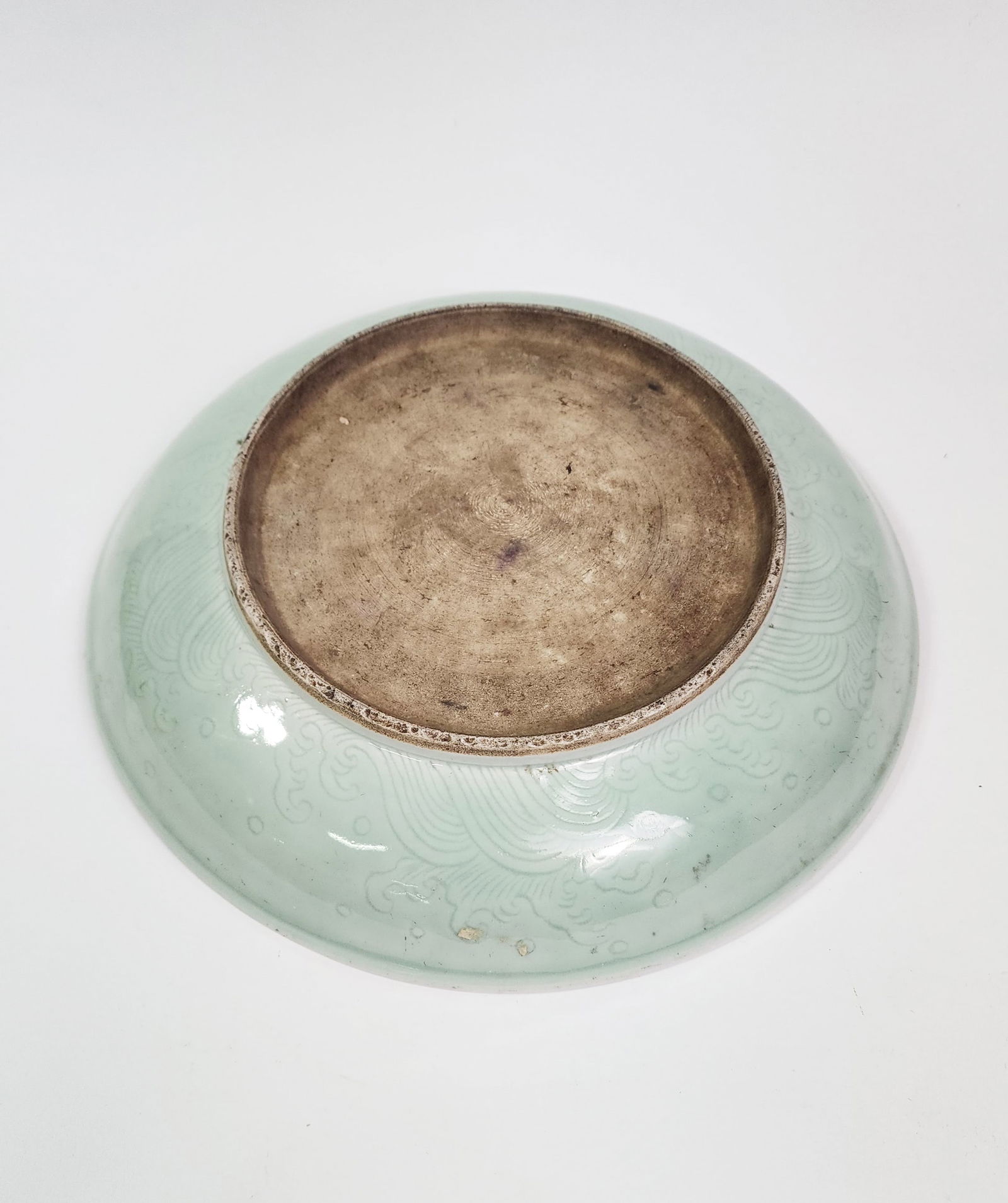 Antique Chinese Qing Celadon Glazed Porcelain Plate: Antique Chinese Qing Celadon Glazed Porcelain Plate, d. 11 inches, h. 2.25 inches.