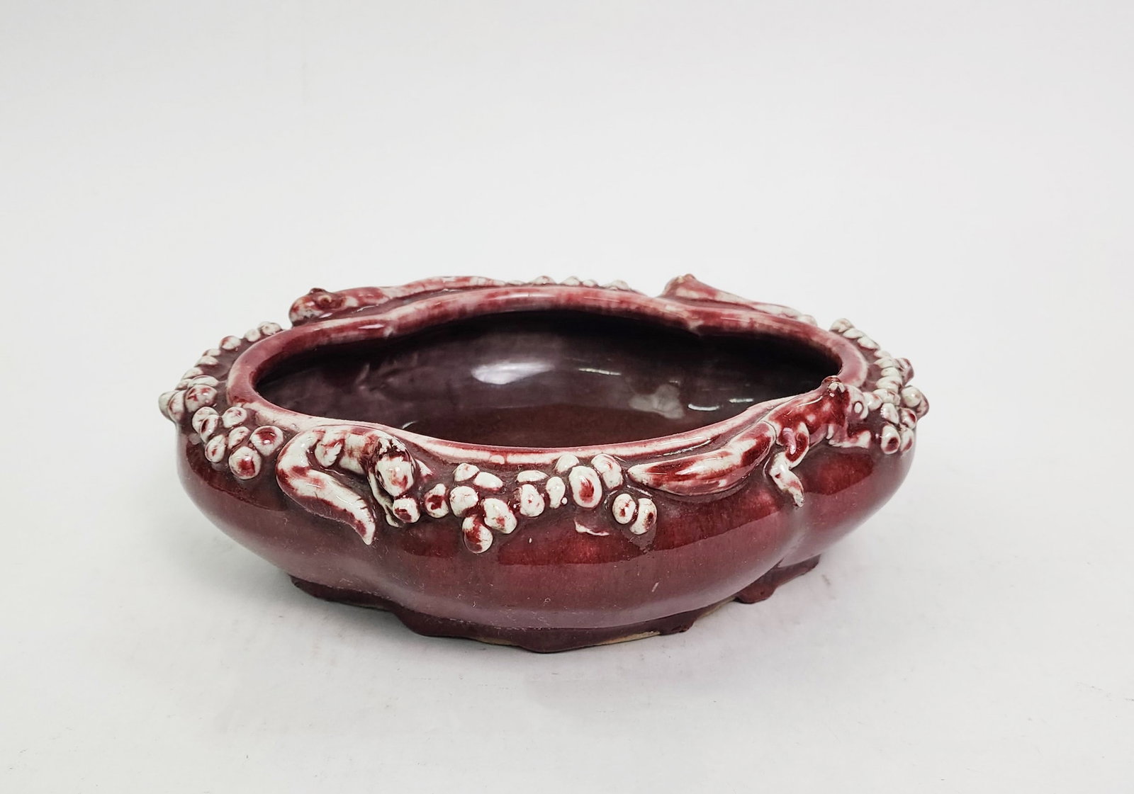 Antique Chinese Red Glazed Porcelain Bowl with Molded Design: Antique Chinese Red Glazed Porcelain Bowl with Molded Squirrel Design, 9.75 x 8 inches, h. 3 in, ca. 19th century.