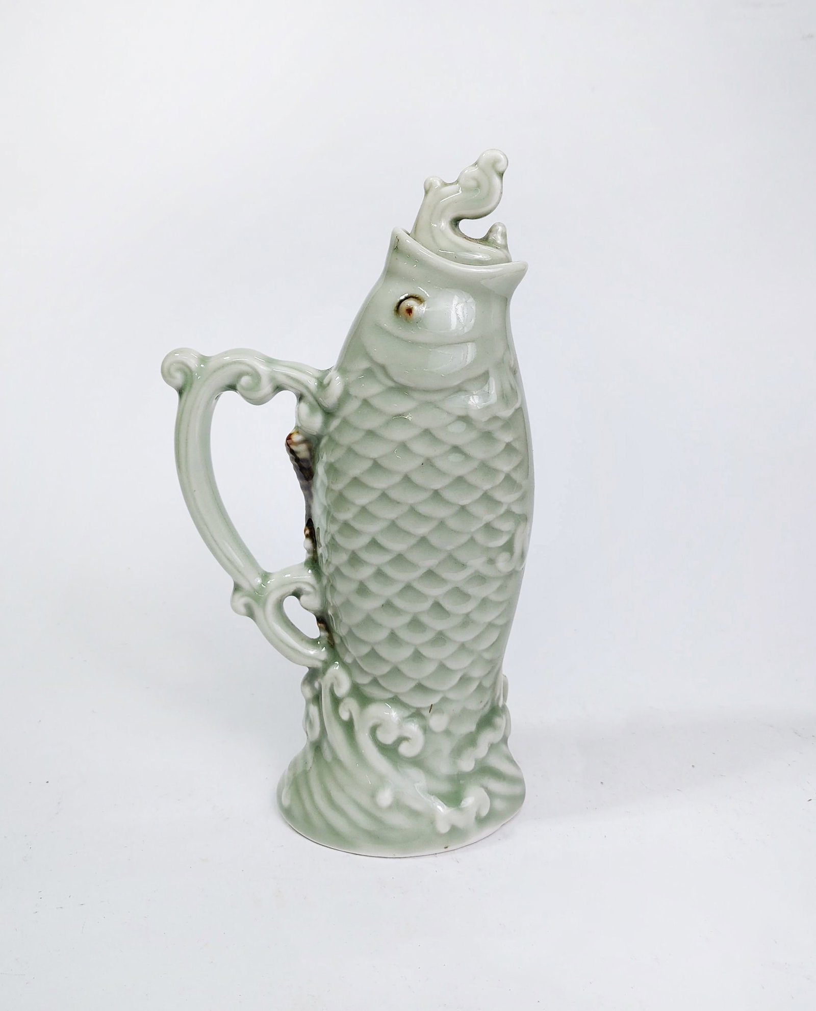 Chinese Celadon Glazed Porcelain Fish Shaped Wine? Pot: Chinese Celadon Glazed Porcelain Fish Shaped Wine? Pot, h. 9 inches.