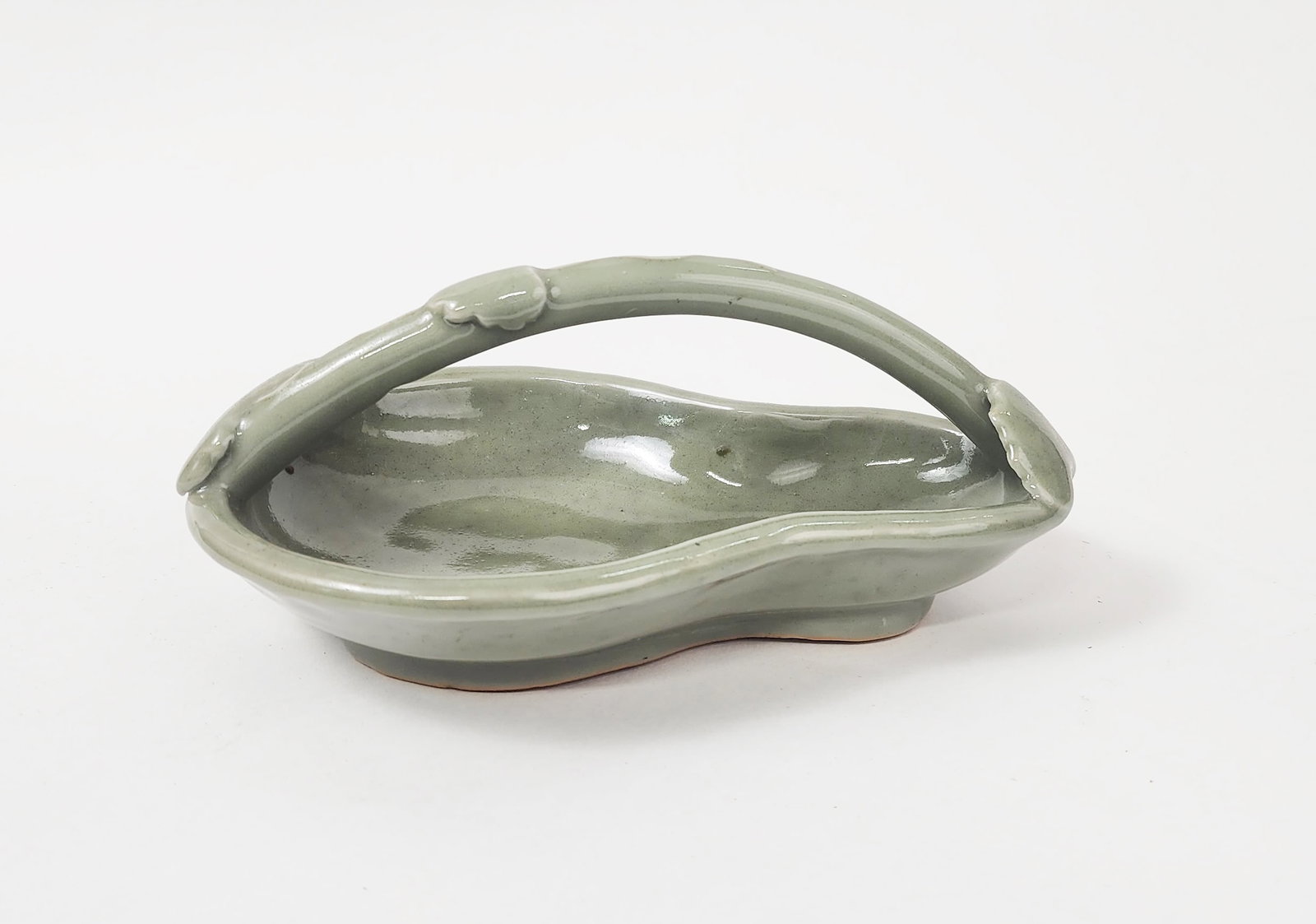 Chinese Celadon Glazed Porcelain Plate w Handle: Chinese Celadon Glazed Porcelain Plate with handle, w. 8.25 inches, h. 3.25 in., ca. 20th century.