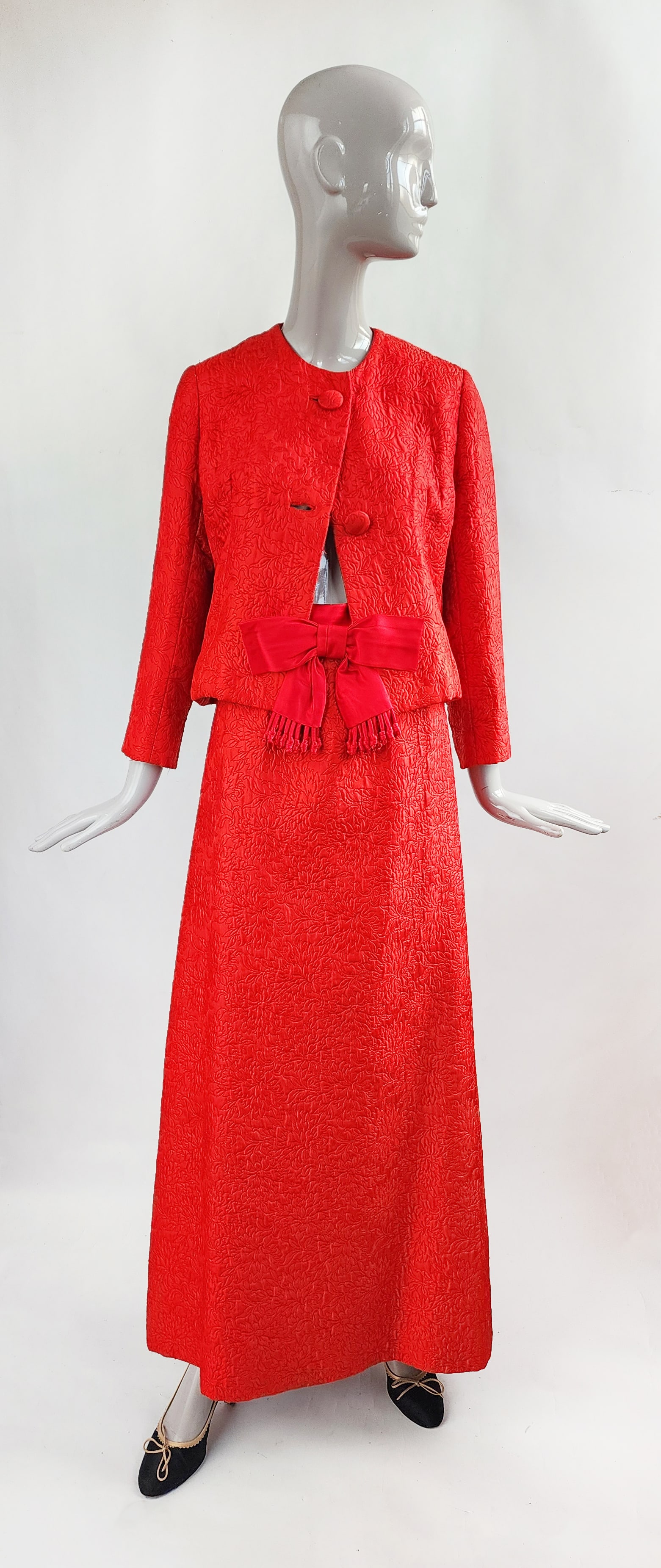 Designer Custom Made Red Floral Silk Jacquard Evening Suit: Designer Custom Made red floral silk jacquard & satin evening suit with bow detail at the skirt waist, ca. early to mid 1960s. Possibly an American copy of a French couture designer. Provenance: Estat