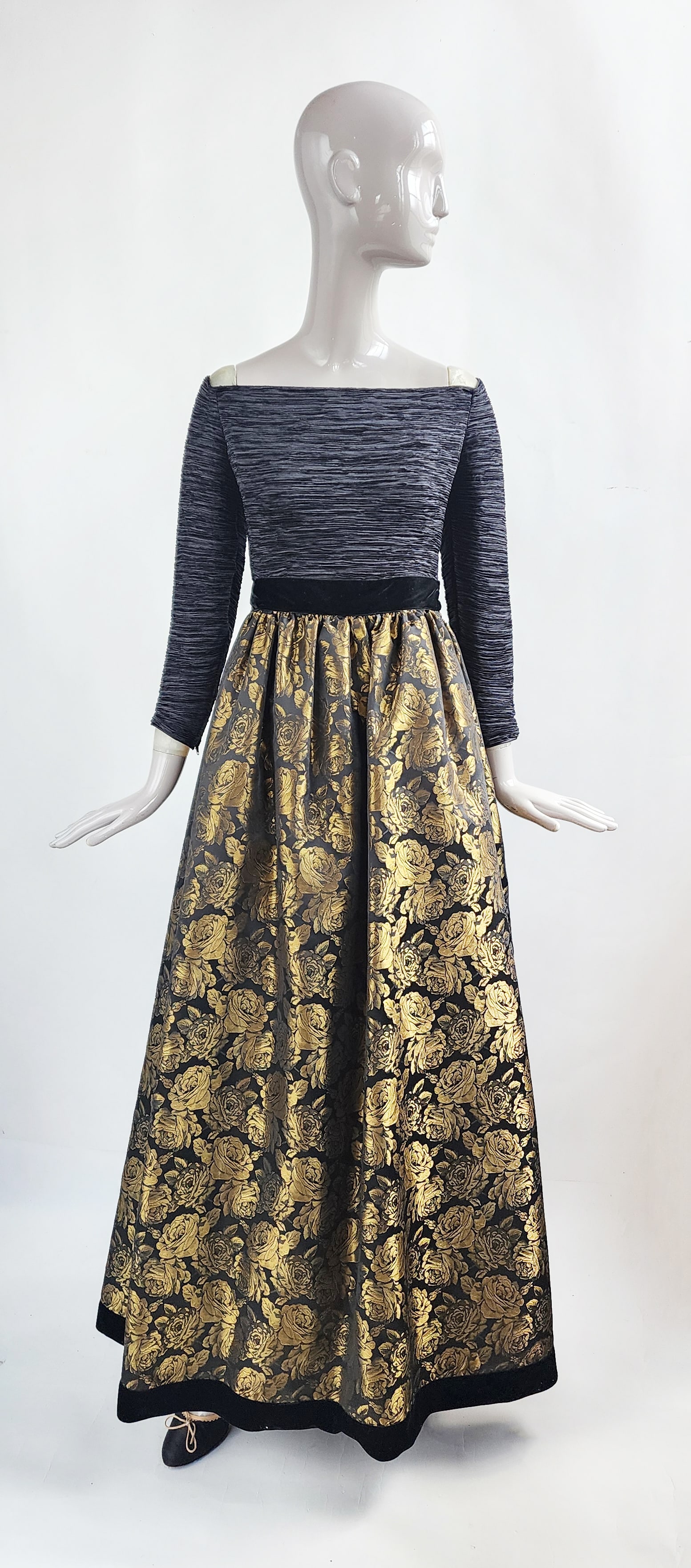 Mary McFadden Black, Gold Metallic Floral Brocade & Fortuny Pleated Evening Dress, 1997: Mary McFadden for Bergdorf Goodman black & gold metallic floral brocade skirt and black Fortuny pleated bodice evening dress with drop shoulder, Fall/ Winter 1997. The designer label is missing. Prove