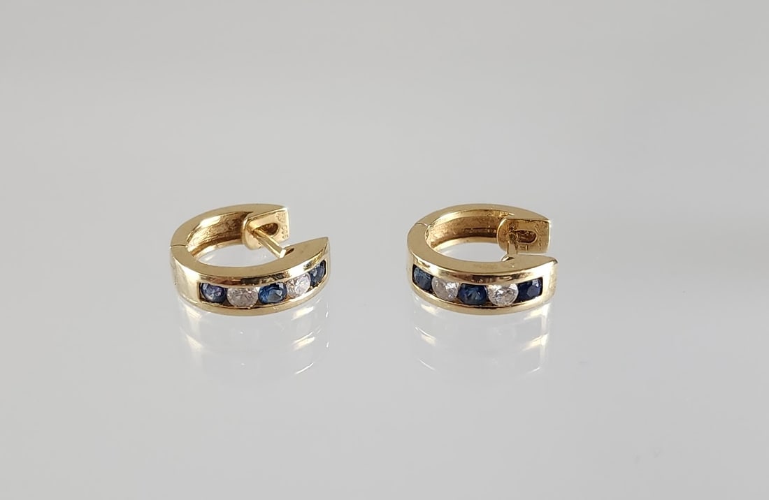 Estate Vintage 14K Gold, Diamond & Sapphire Earrings: Estate Vintage 14K Gold, Diamond & Sapphire Huggie Earrings. Marks: Total weight: 2.9 grams. Provenance: Estate of Victoria Salter (1944-2024) Victoria Salter was the daughter of Harry Salter, creator