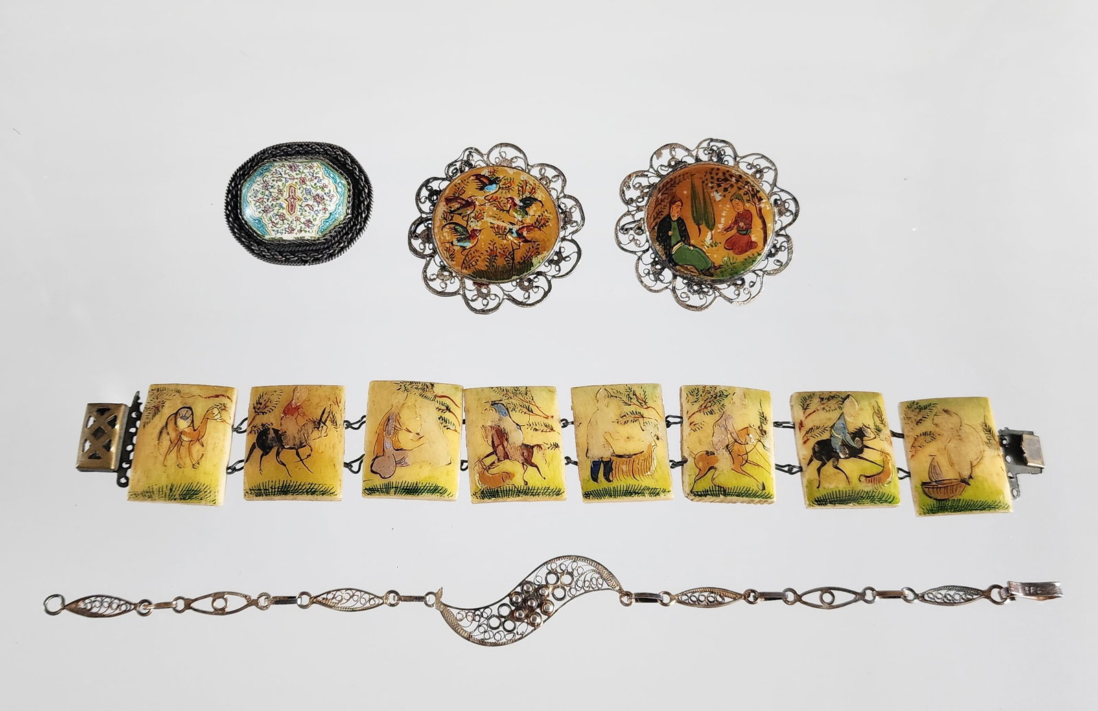 Group of Estate Vintage Persian Hand Painted & Silver Filigree Jewelry: Group of Estate Vintage Persian Hand Painted & Silver Filigree Jewelry. Including; pair of Persian hand painted miniature art mother-of-pearl & silver filigree brooches, 825 silver filigree bracelet, 